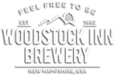 Outline of a Mountain with white letters underneath that spell Woodstock Inn Brewery