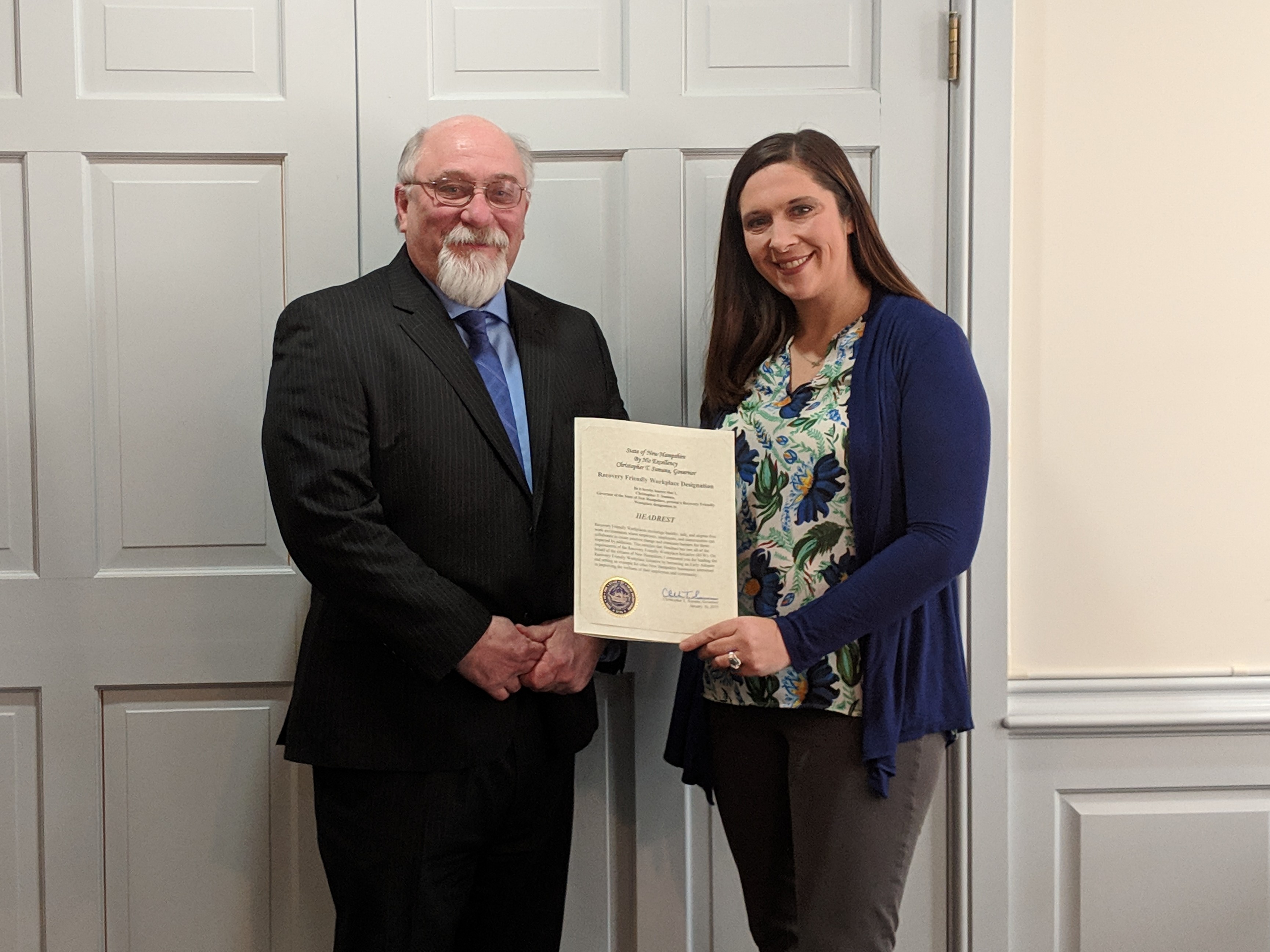 Cameron Ford from Headrest receives designation certificate from Shannon Bresaw, Program Director